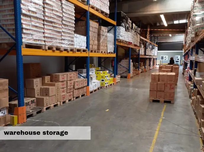 Pallets and cartons along a warehouse aisle